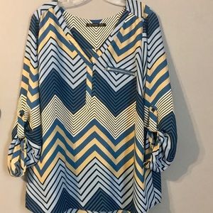 Long sleeve dressy blouse with zipper pocket.